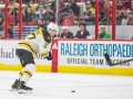December 23, 2018: Boston Bruins defenseman John Moore (27) takes a shot in the second period of the NHL game between the Boston Bruins and the Carolina Hurricanes at PNC Arena in Raleigh, NC. Jonathan Huff/CSM