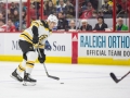 December 23, 2018: Boston Bruins defenseman John Moore (27) takes a shot in the second period of the NHL game between the Boston Bruins and the Carolina Hurricanes at PNC Arena in Raleigh, NC. Jonathan Huff/CSM